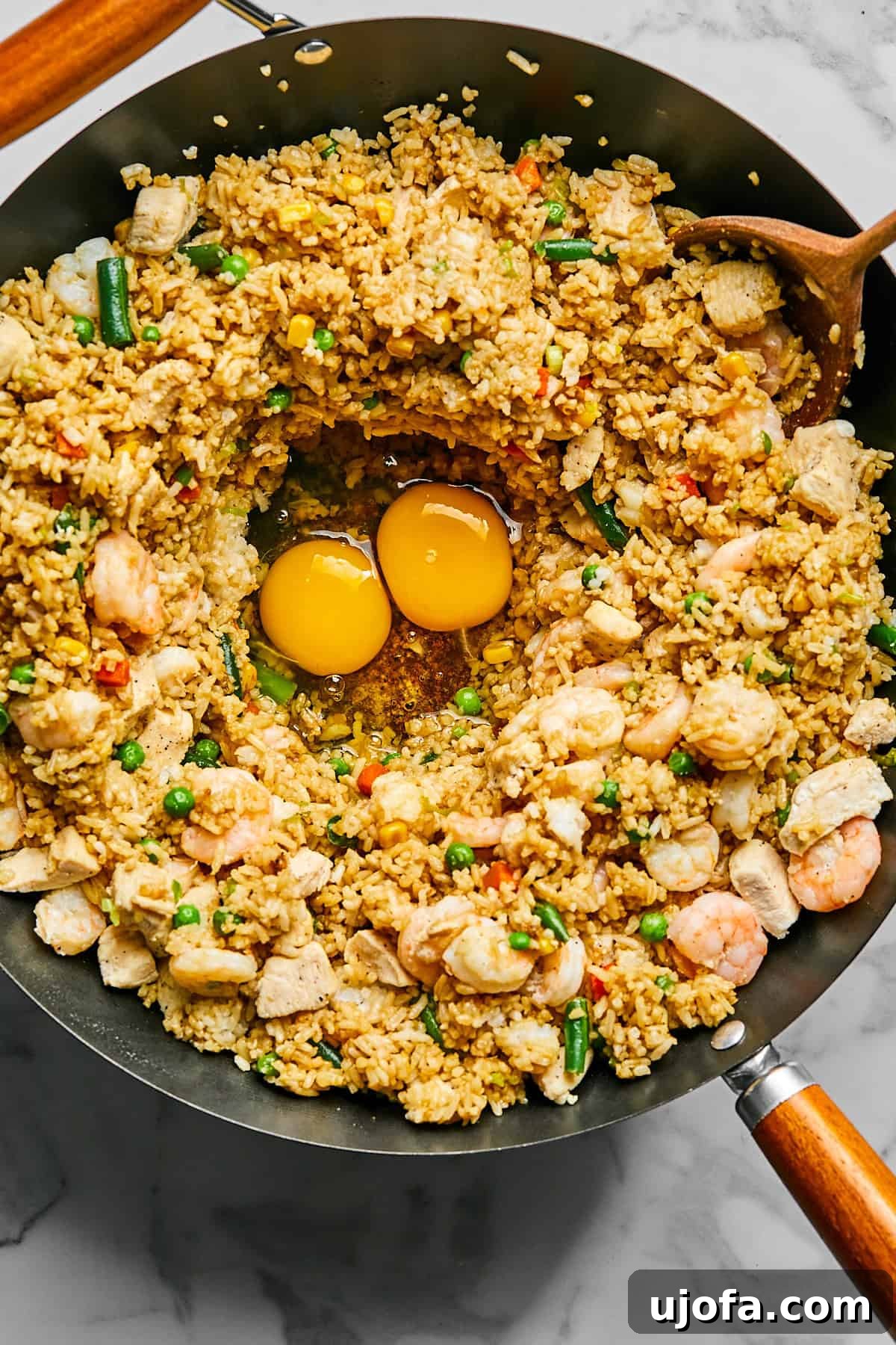 Eggs scrambled directly into the fried rice in the skillet
