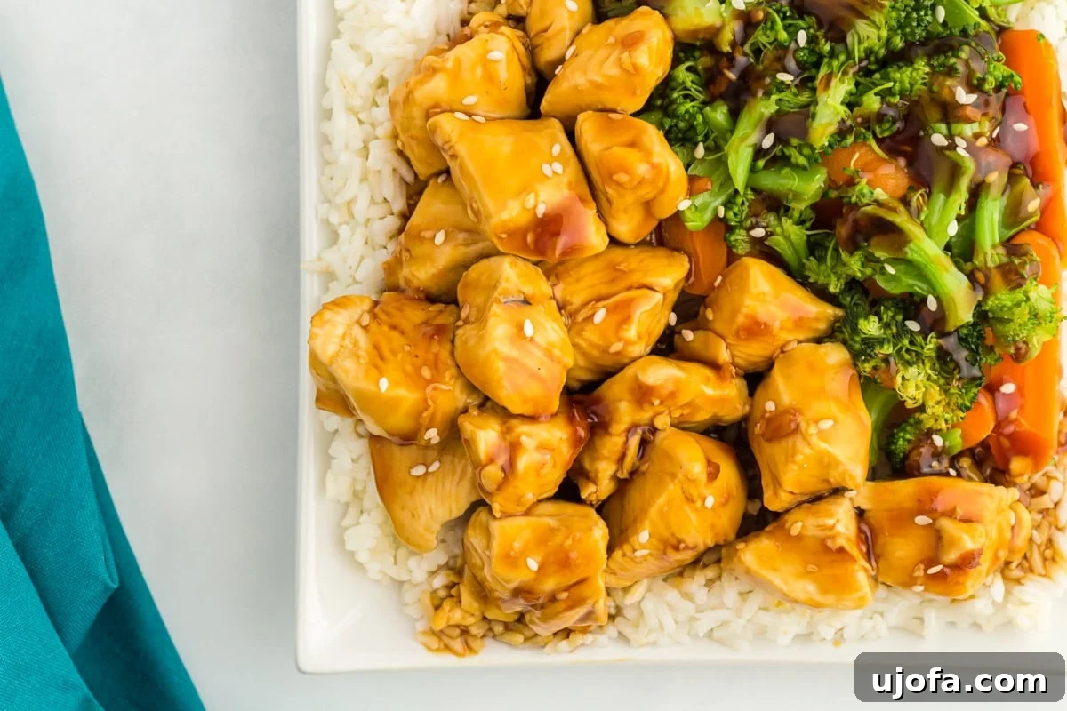 Overhead view of a plate with chicken, vegetables, and rice covered in gluten free teriyaki sauce.
