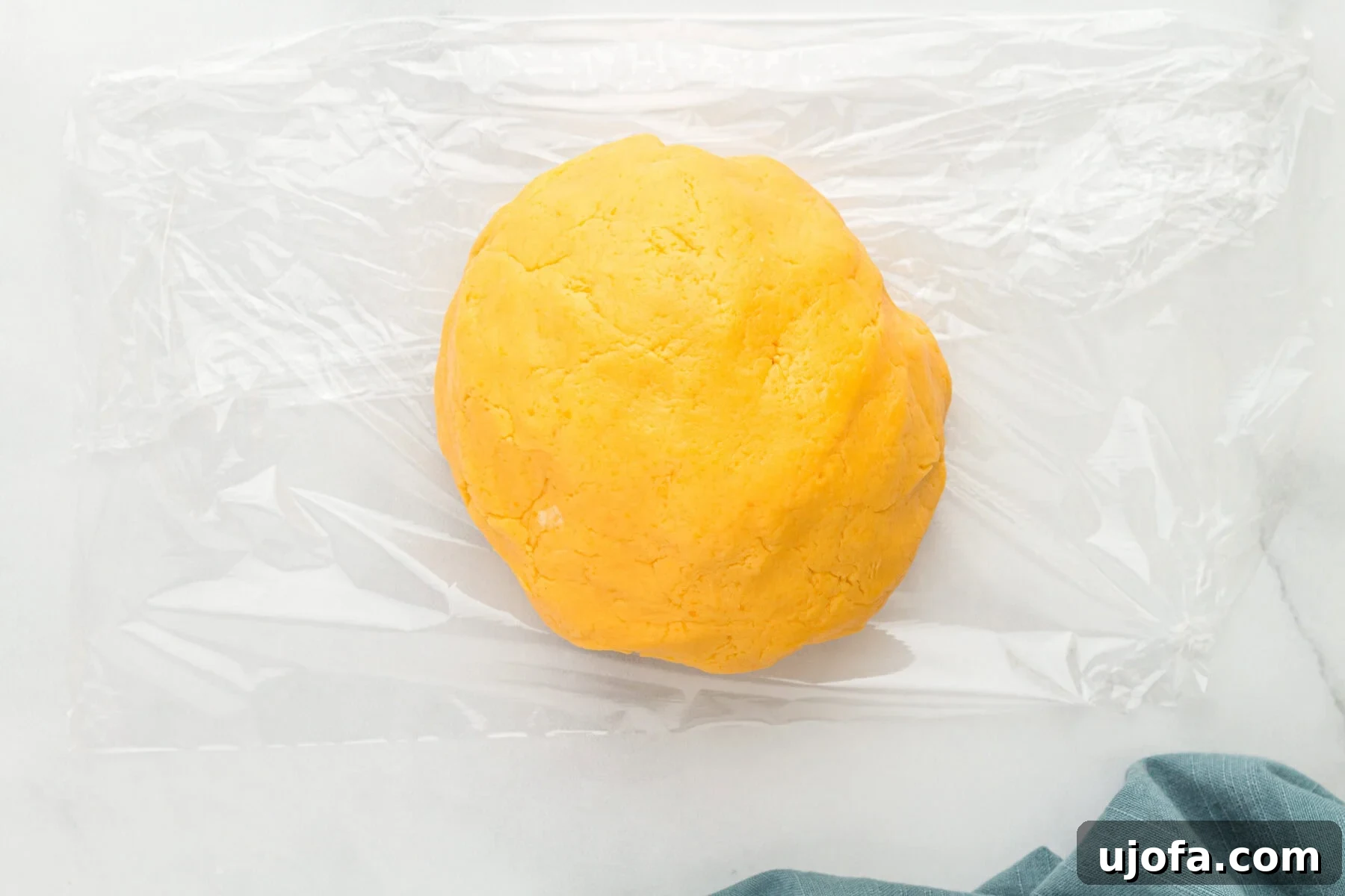 Overhead view of a perfectly shaped gluten-free Cheez-Its dough ball.