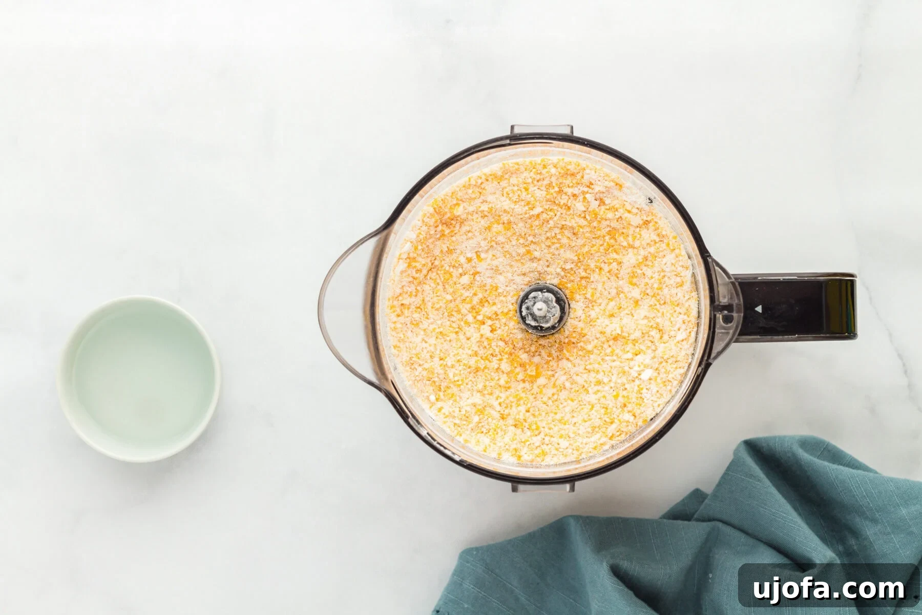 Blended dry mixture for gluten-free Cheez-Its, resembling breadcrumbs in a blender.