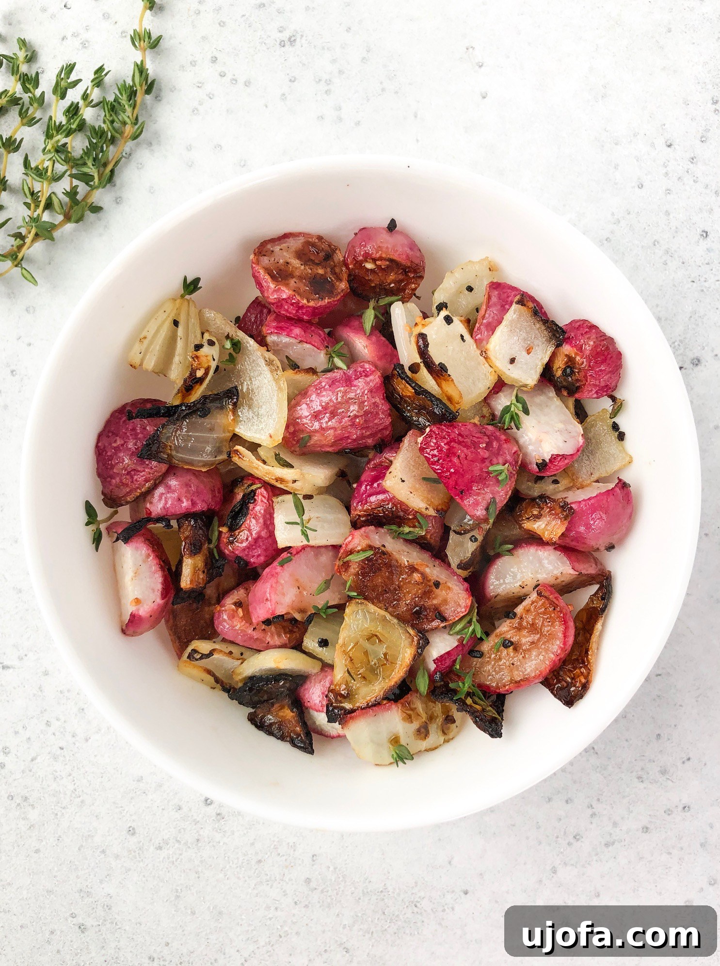 Close-up of crispy Thyme Roasted Radishes and Onions, perfectly browned and ready to serve.
