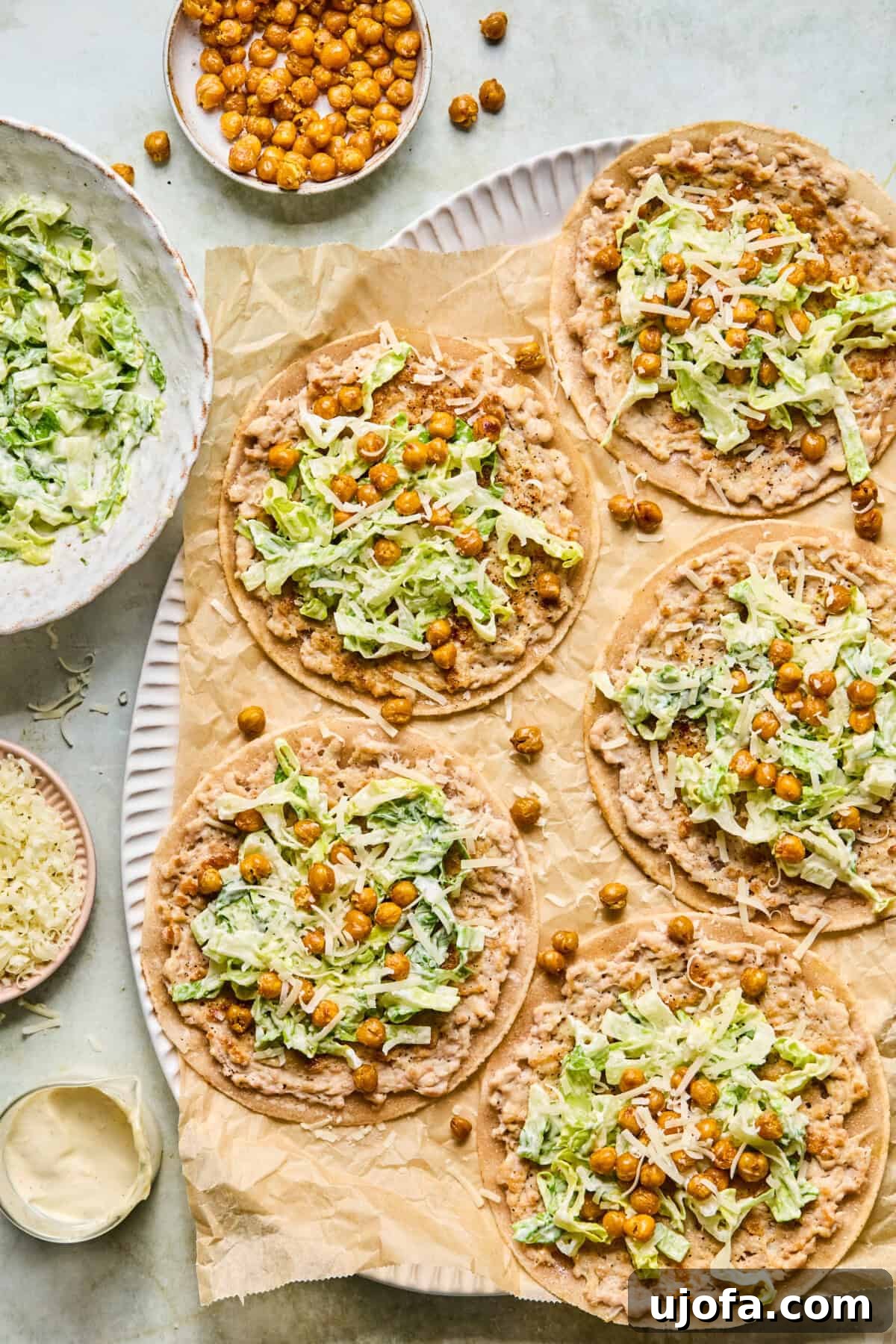 chicken caesar smash burger tacos served on tortillas with crispy chickpeas and romaine