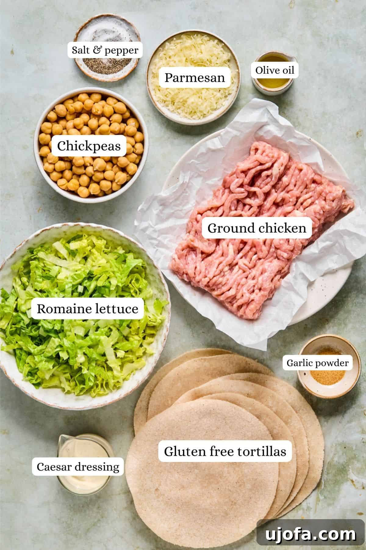overhead shot of ingredients for chicken caesar smash tacos, including romaine, chickpeas, and tortillas