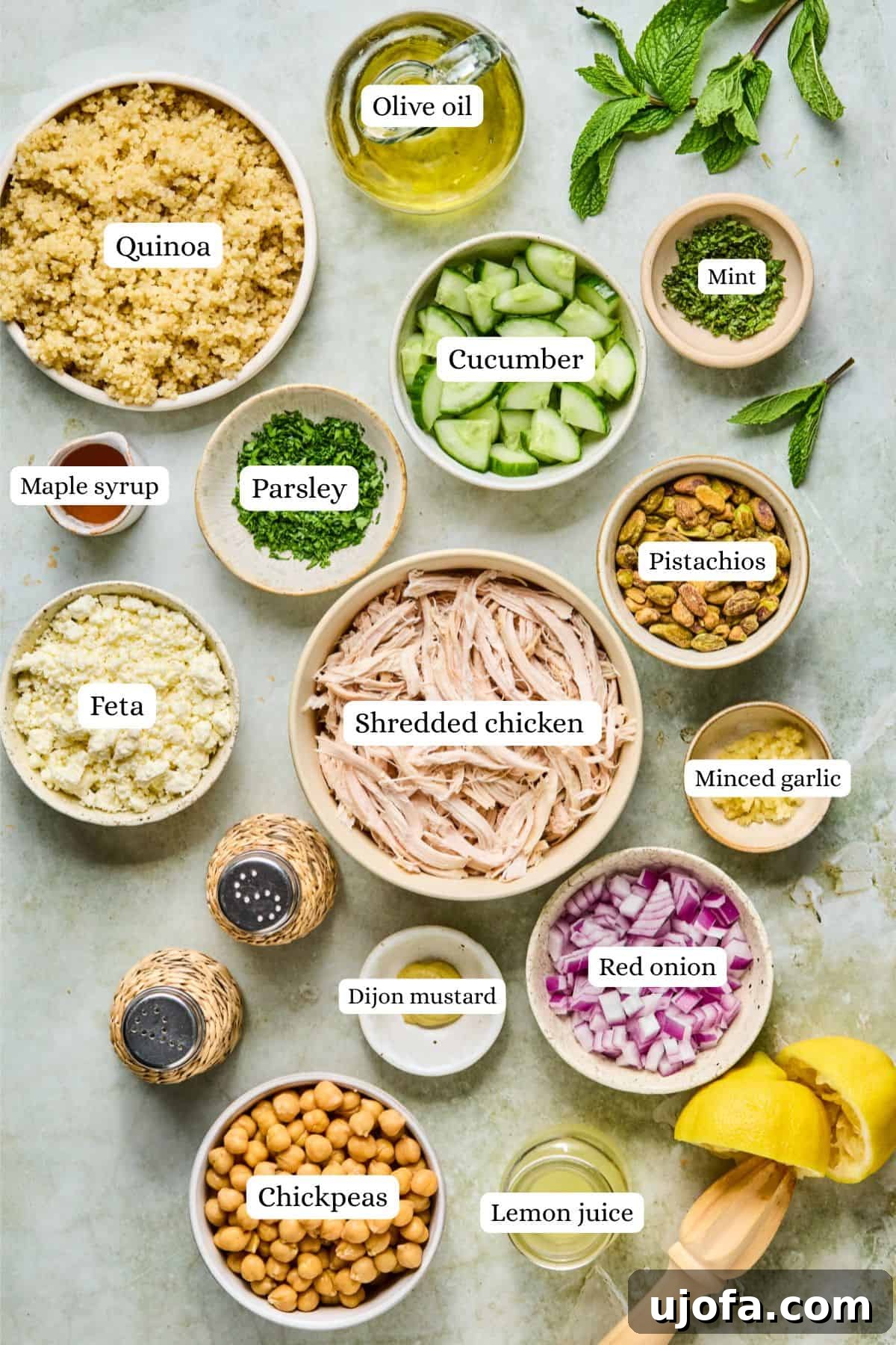 Jennifer Aniston Protein Power Prep Salad 3 Overhead shot showcasing a bounty of fresh salad ingredients, including vibrant cooked quinoa, crisp cucumber, protein-rich chickpeas, and aromatic fresh parsley, ready for assembly.