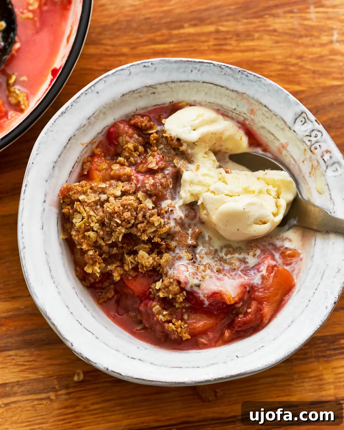 Golden Gluten-Free Peach Crisp 5 Gluten-free peach crisp in a bowl with vanilla ice cream.