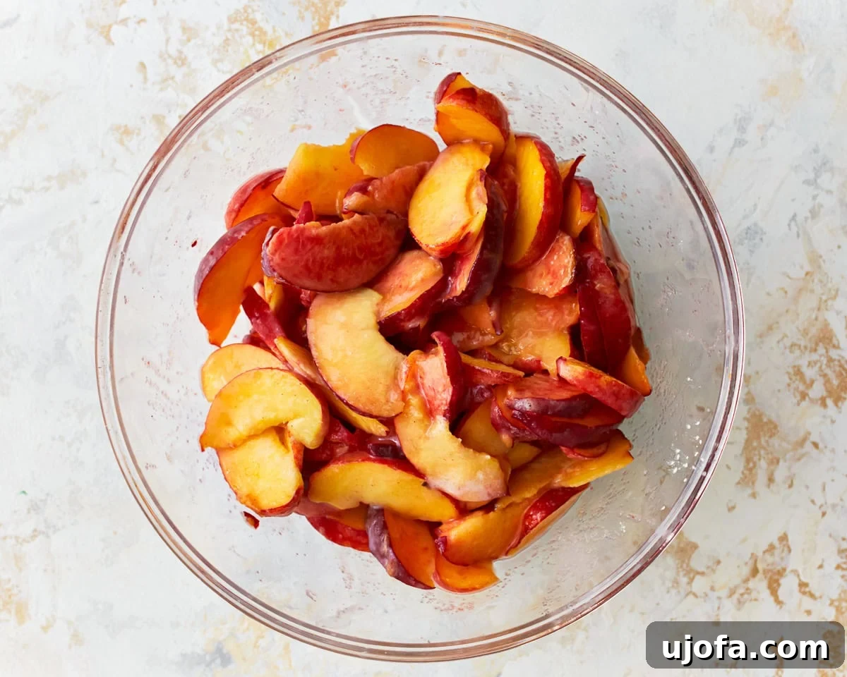 Golden Gluten-Free Peach Crisp 6 Sliced peaches in a bowl.