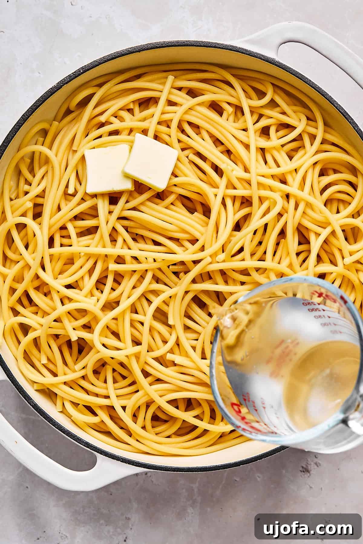 Simple 5 Ingredient Gluten Free Bucatini Cacio e Pepe 5 Cooked bucatini in a skillet with melted butter and reserved pasta water