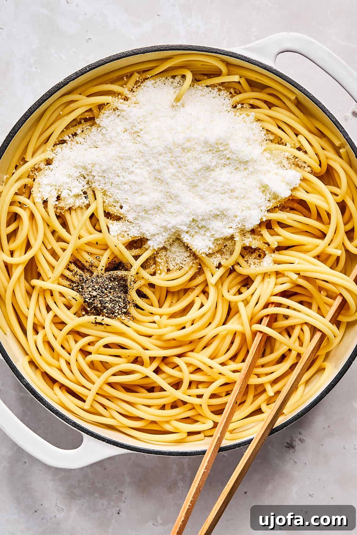 Simple 5 Ingredient Gluten Free Bucatini Cacio e Pepe 6 Stirring pecorino romano and black pepper into hot pasta in skillet