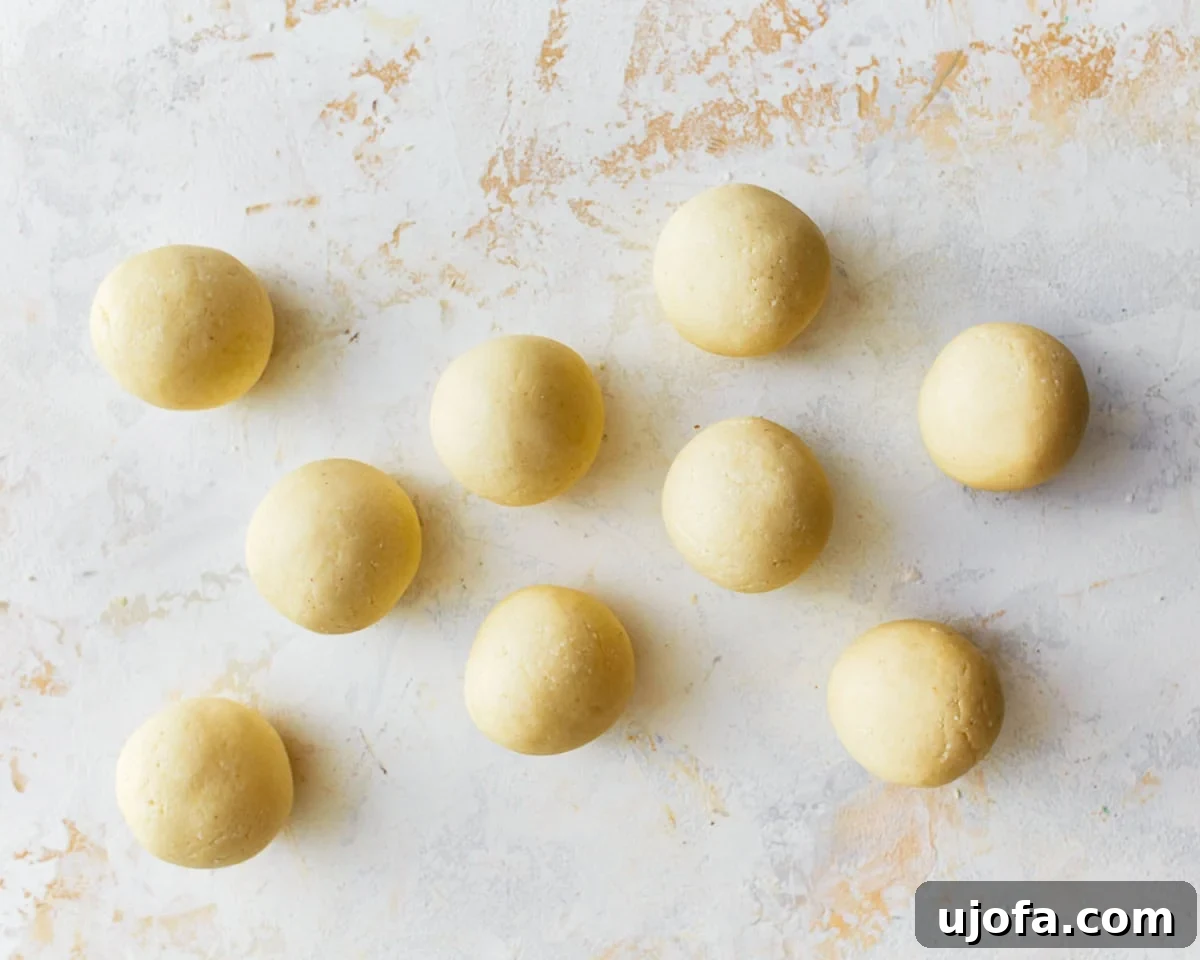 Golden Pandebono Colombian Bakery Classic 9 Multiple uniformly shaped balls of pandebono bread dough, perfectly rounded and ready for baking.