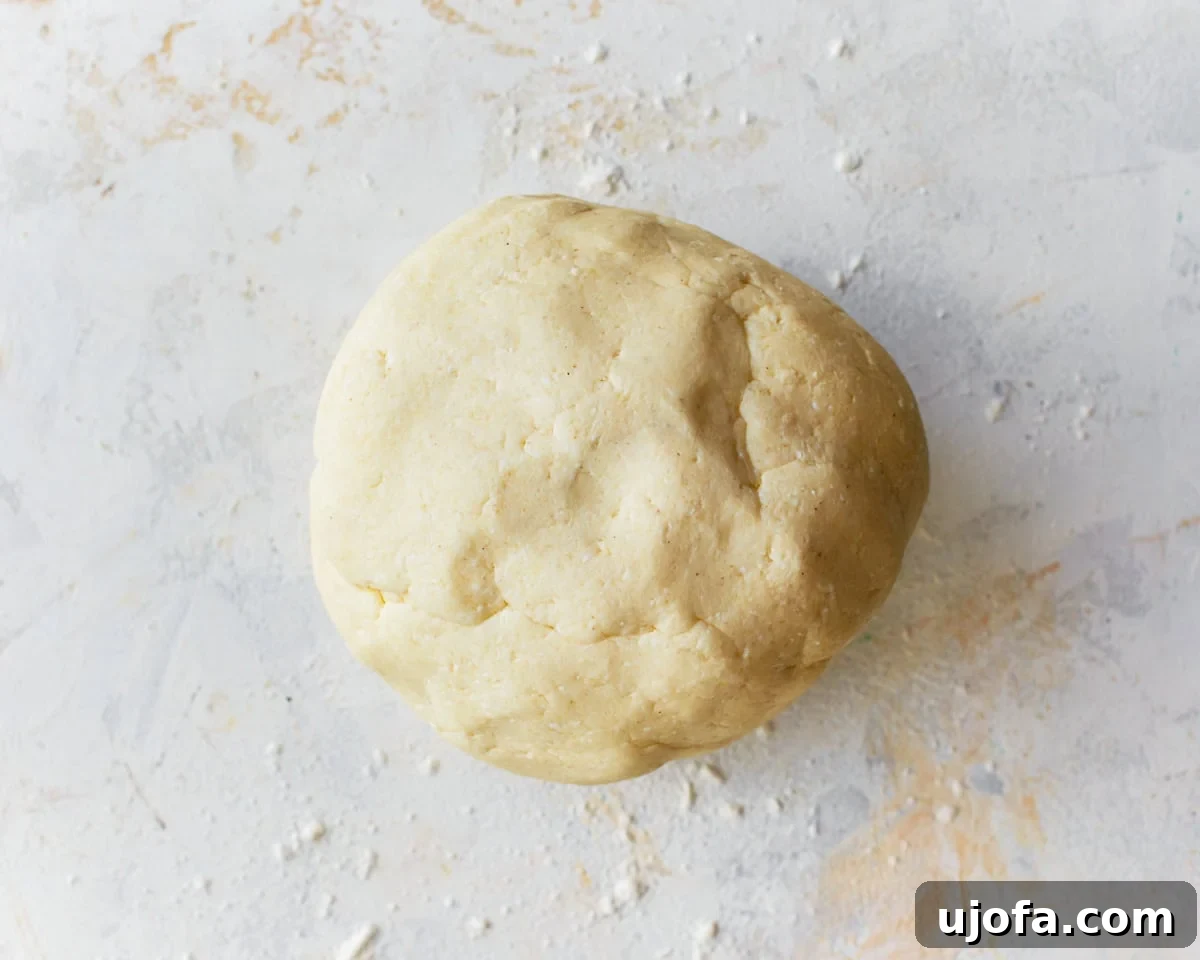 Golden Pandebono Colombian Bakery Classic 8 Freshly mixed pandebono bread dough resting on a clean surface lightly dusted with tapioca flour, ready for shaping.