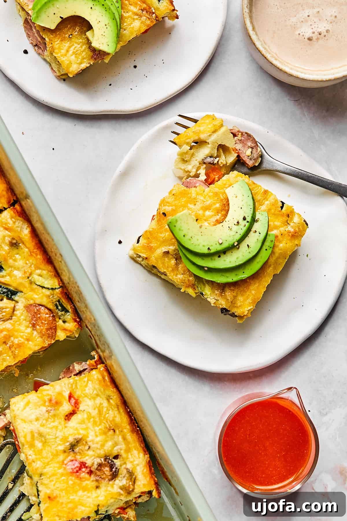 Hearty Cottage Cheese and Chicken Sausage Brunch Bake 12 Close-up of a plated slice of cottage cheese egg bake garnished with avocado