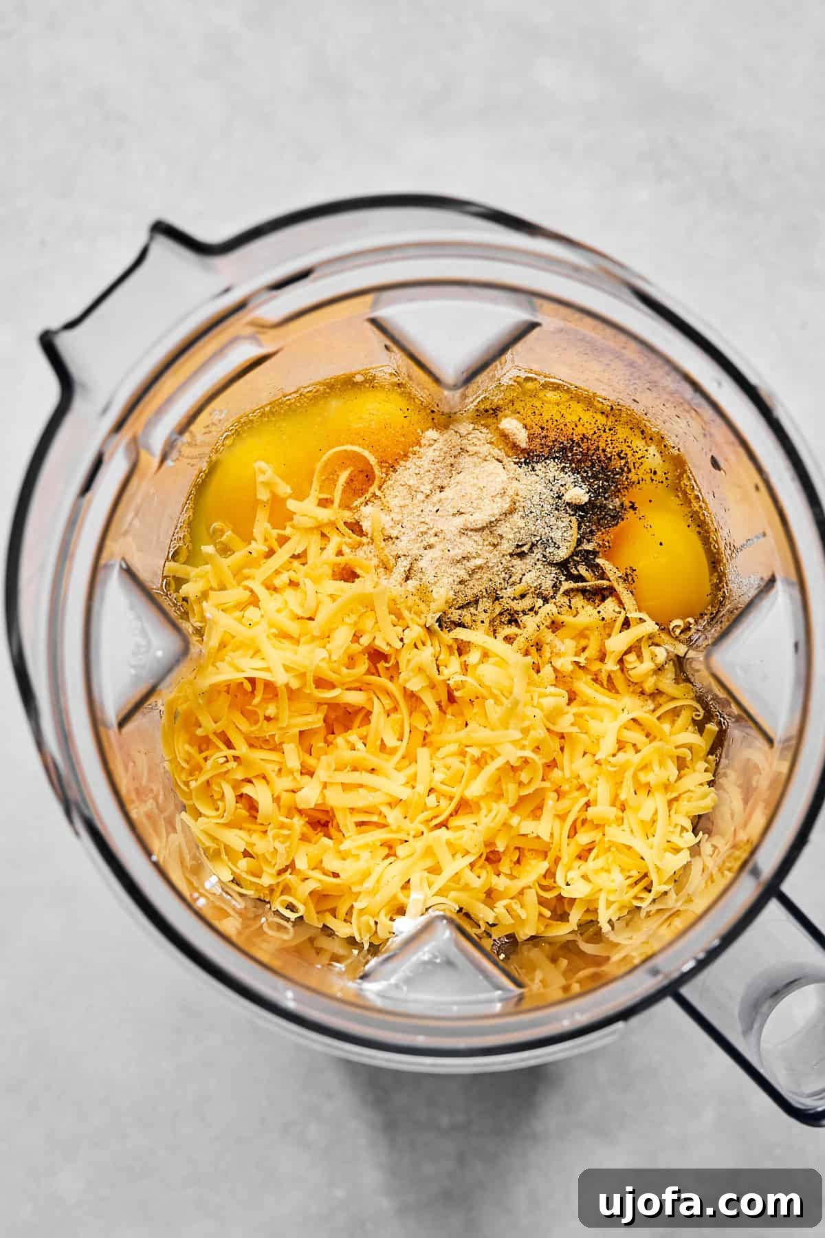 Hearty Cottage Cheese and Chicken Sausage Brunch Bake 4 Blender with eggs, cottage cheese, and shredded cheddar ready to be blended