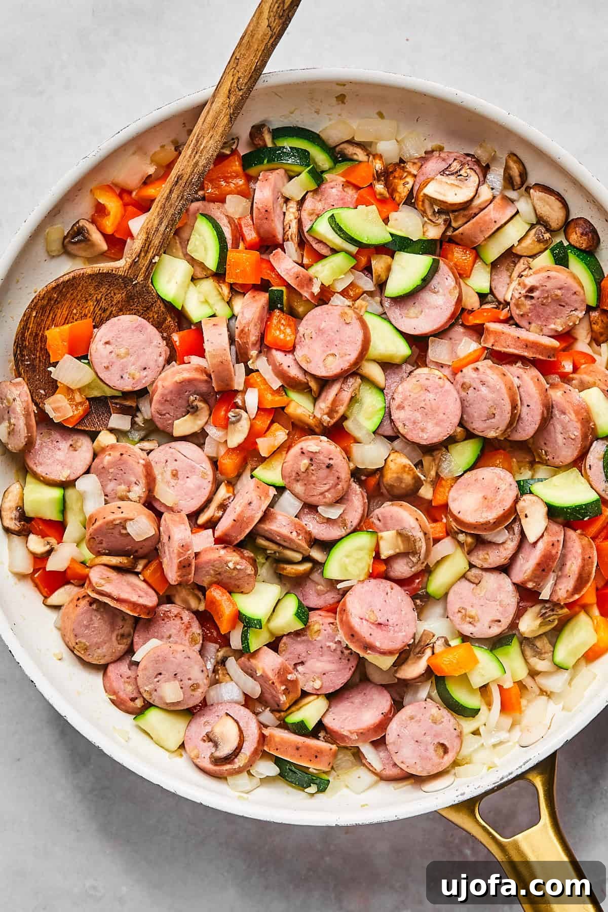 Hearty Cottage Cheese and Chicken Sausage Brunch Bake 6 Skillet with browned chicken sausage, diced red pepper, mushrooms, zucchini, and onions
