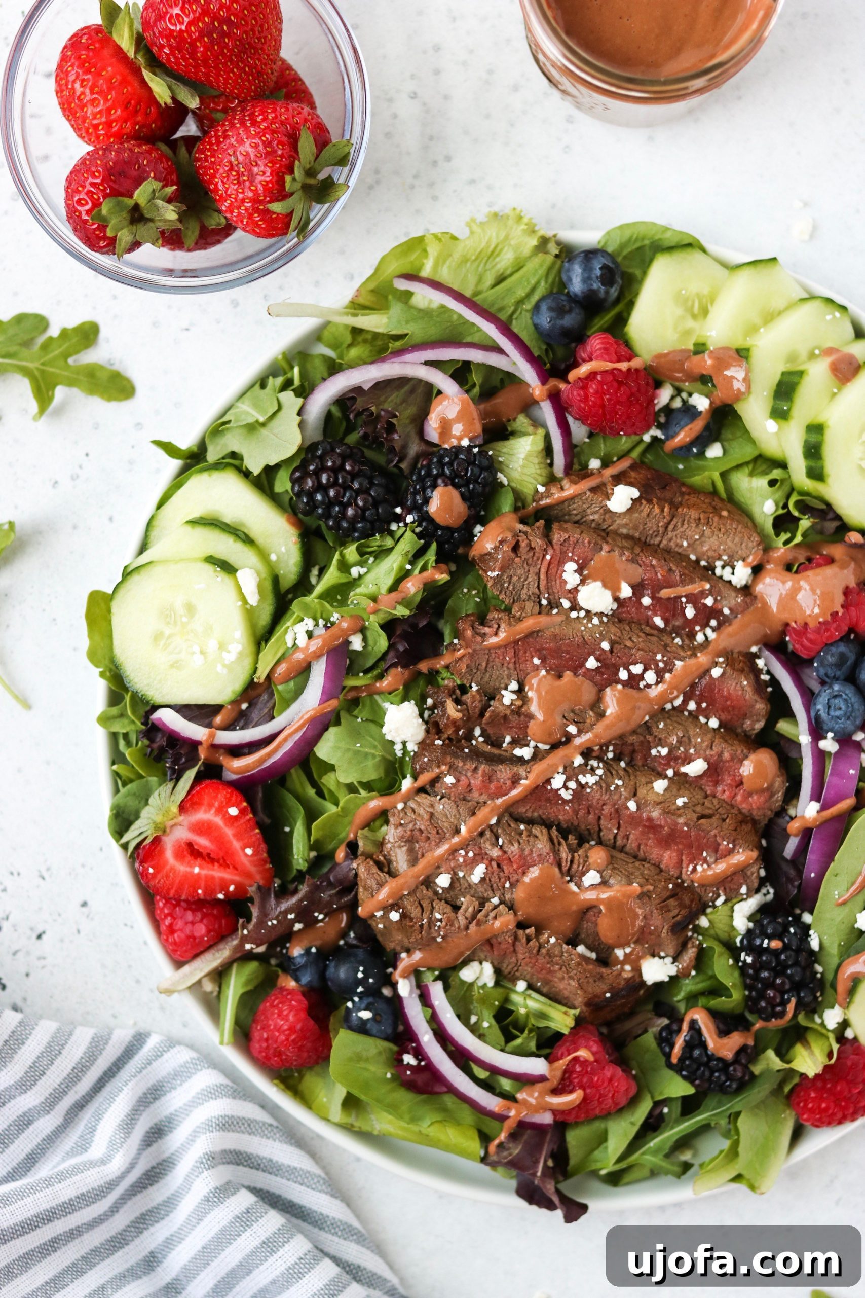 A beautifully plated Aussie Tenderloin Salad with Strawberry Balsamic Vinaigrette, ready to be served.