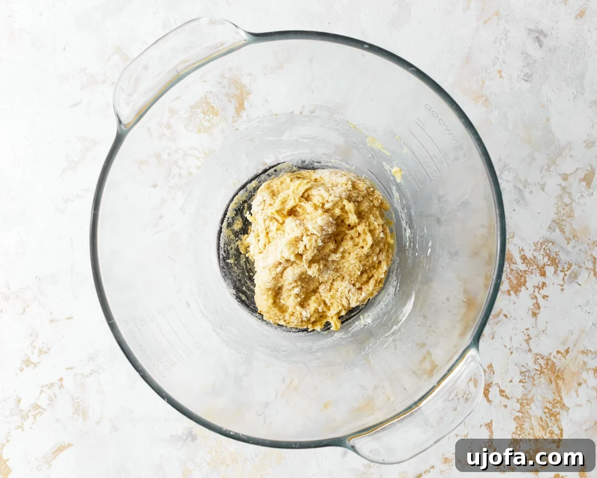 Mixed ingredients for almond flour pasta dough in a glass bowl