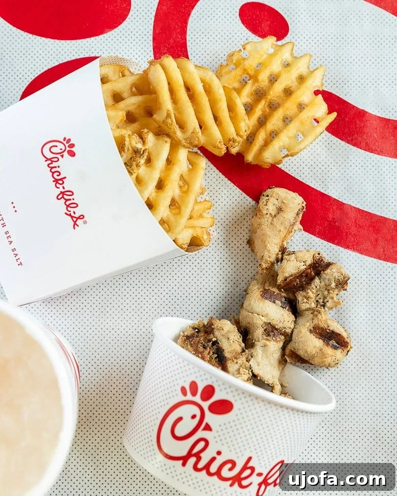 Crispy waffle fries and juicy grilled chicken nuggets from Chick-fil-A, perfect for a gluten-friendly meal.