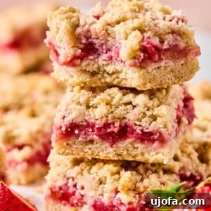 strawberry rhubarb crumble bars stacked on top of each other