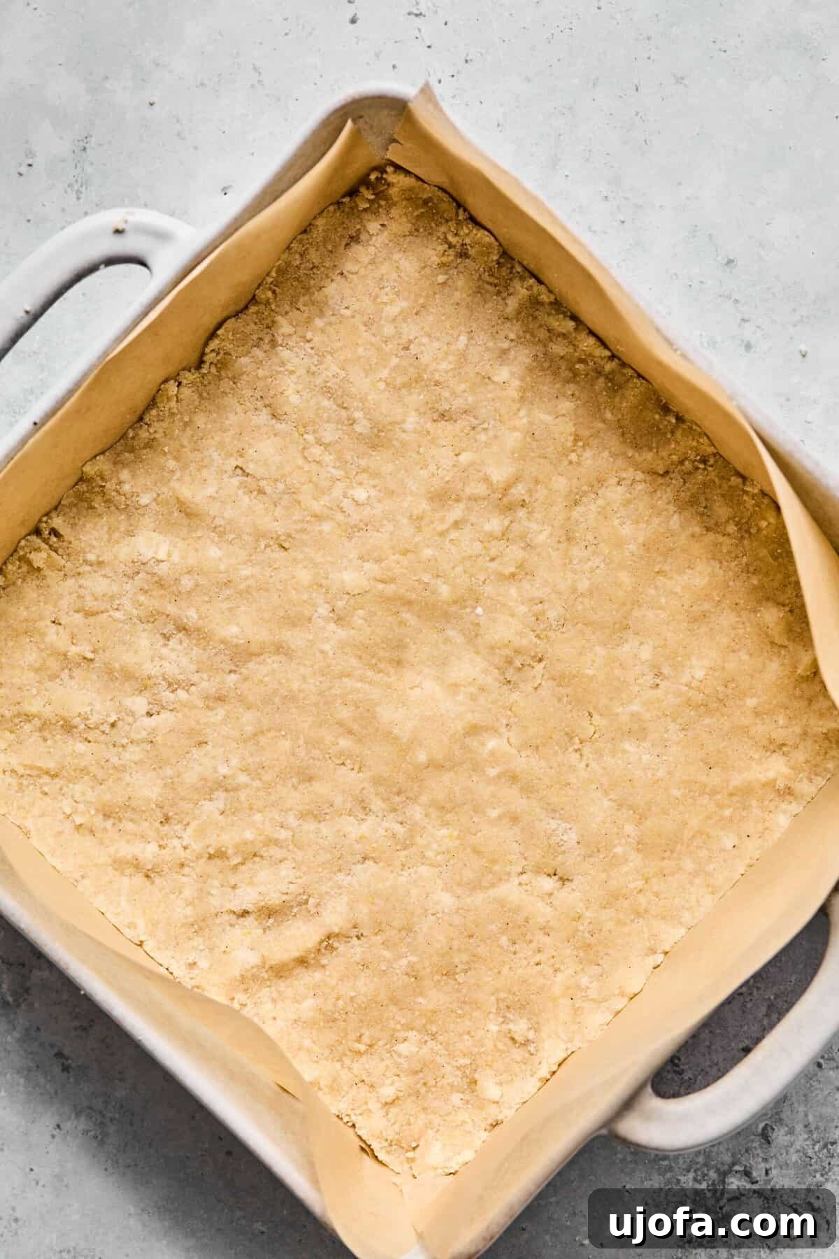 Pressed in half of the crumble dough into the bottom of a parchment-lined 9×9-inch pan