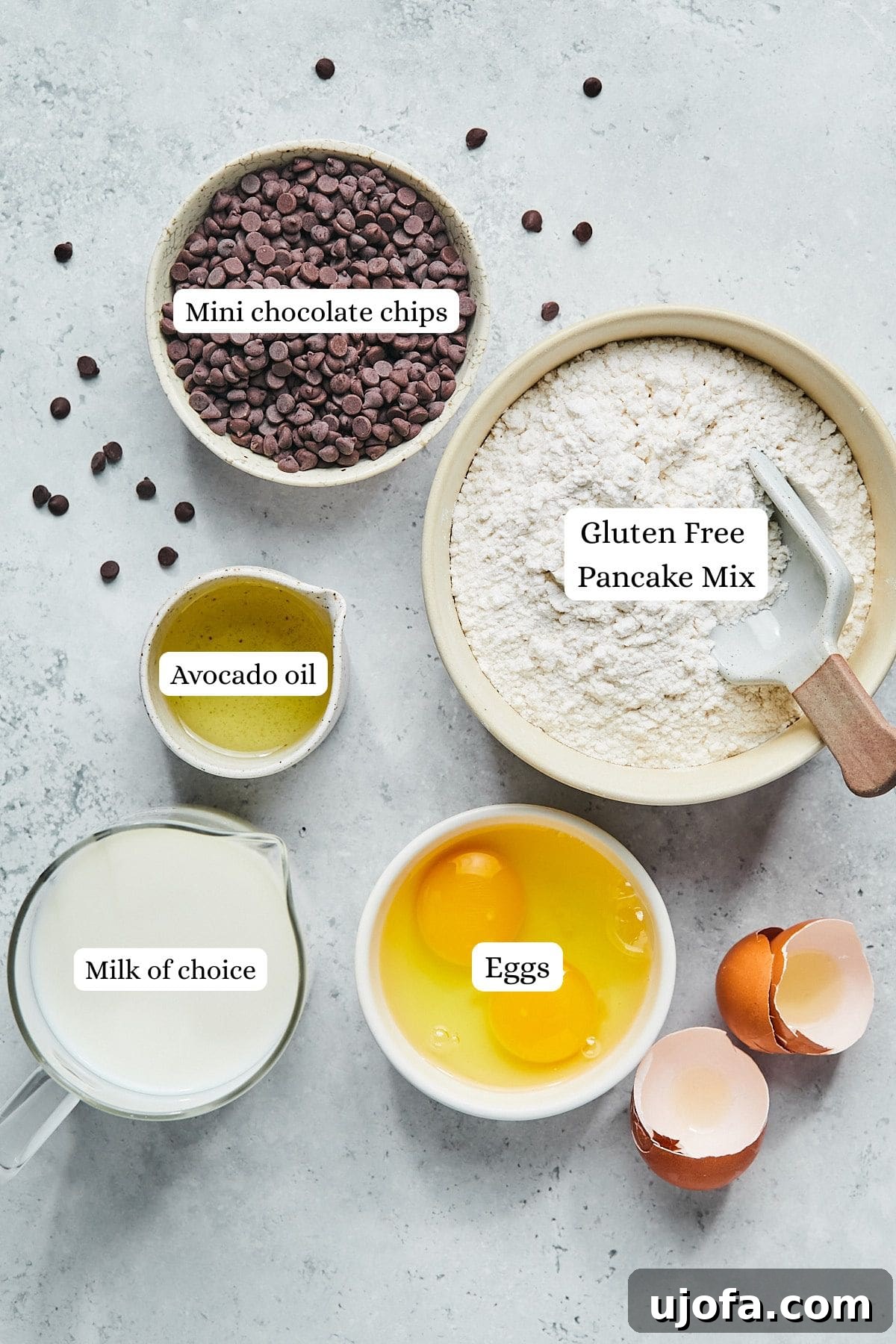 Five simple ingredients for gluten-free mini muffins: pancake mix, almond milk, eggs, avocado oil, and mini chocolate chips