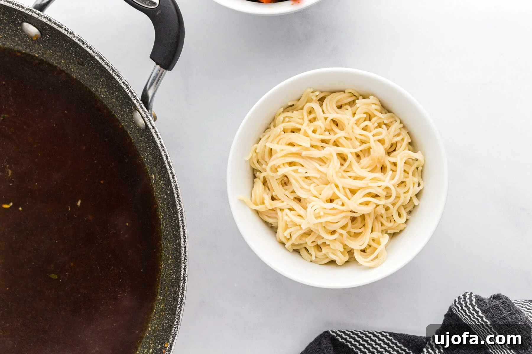 A bowl filled with perfectly cooked gluten-free ramen noodles, waiting for the broth and toppings.