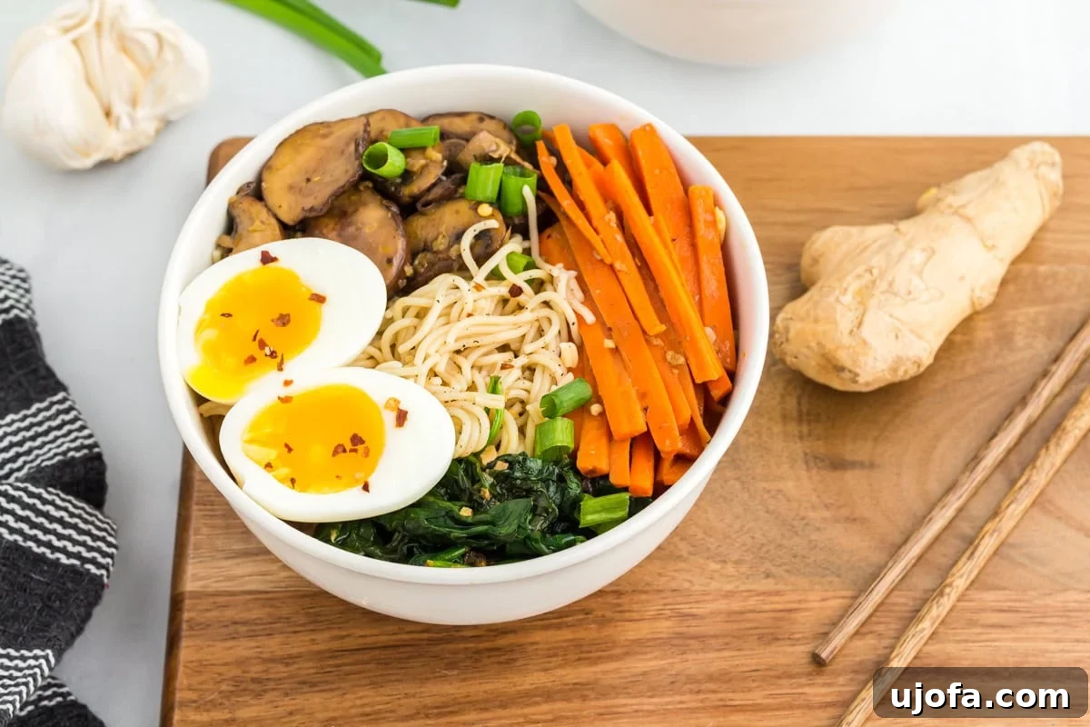 Side view of a bowl of gluten-free ramen, showing the vibrant broth, noodles, and toppings.