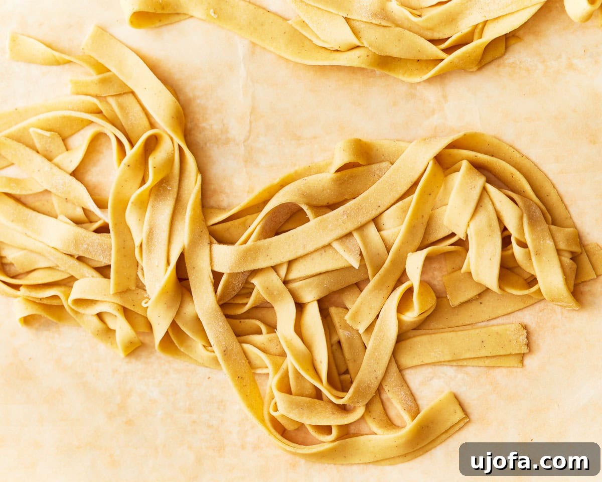 Freshly cooked gluten-free egg noodles, perfectly golden and chewy, ready to be served.