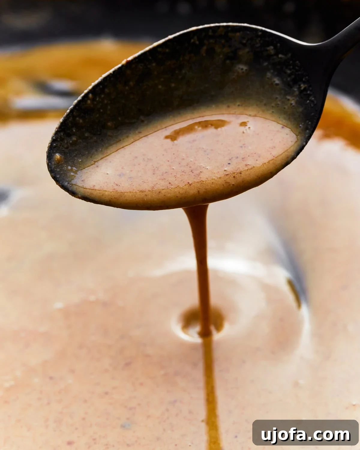 Mastering Gluten-Free Roux 5 Close up of a spoon scooping gluten-free roux from a skillet.