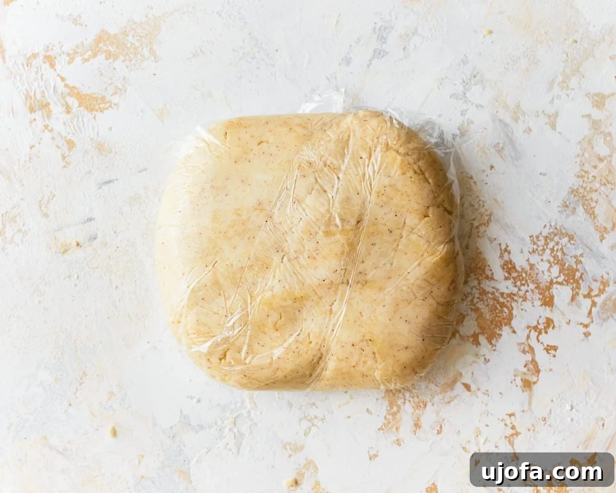 Buttery Golden Gluten-Free Crackers 10 A smooth ball of gluten-free ritz cracker dough wrapped tightly in clear plastic wrap, ready for chilling.