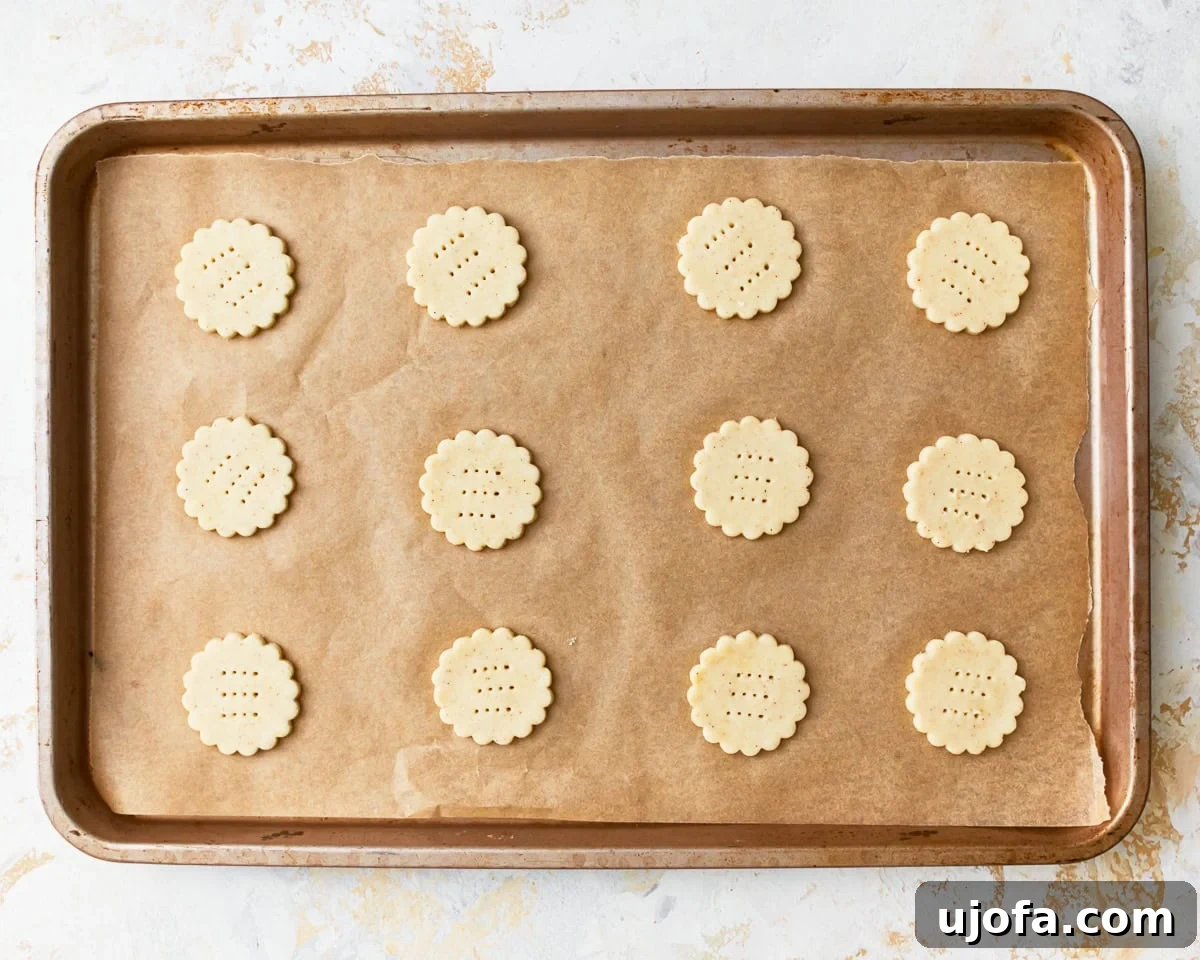 Buttery Golden Gluten-Free Crackers 13 Unbaked gluten-free ritz crackers, pricked with a fork, arranged on a parchment-lined baking sheet, spaced apart.