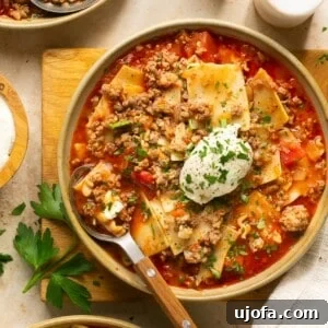 gluten free lasagna soup in 3 bowls with a dollop of ricotta cheese and parsley on top