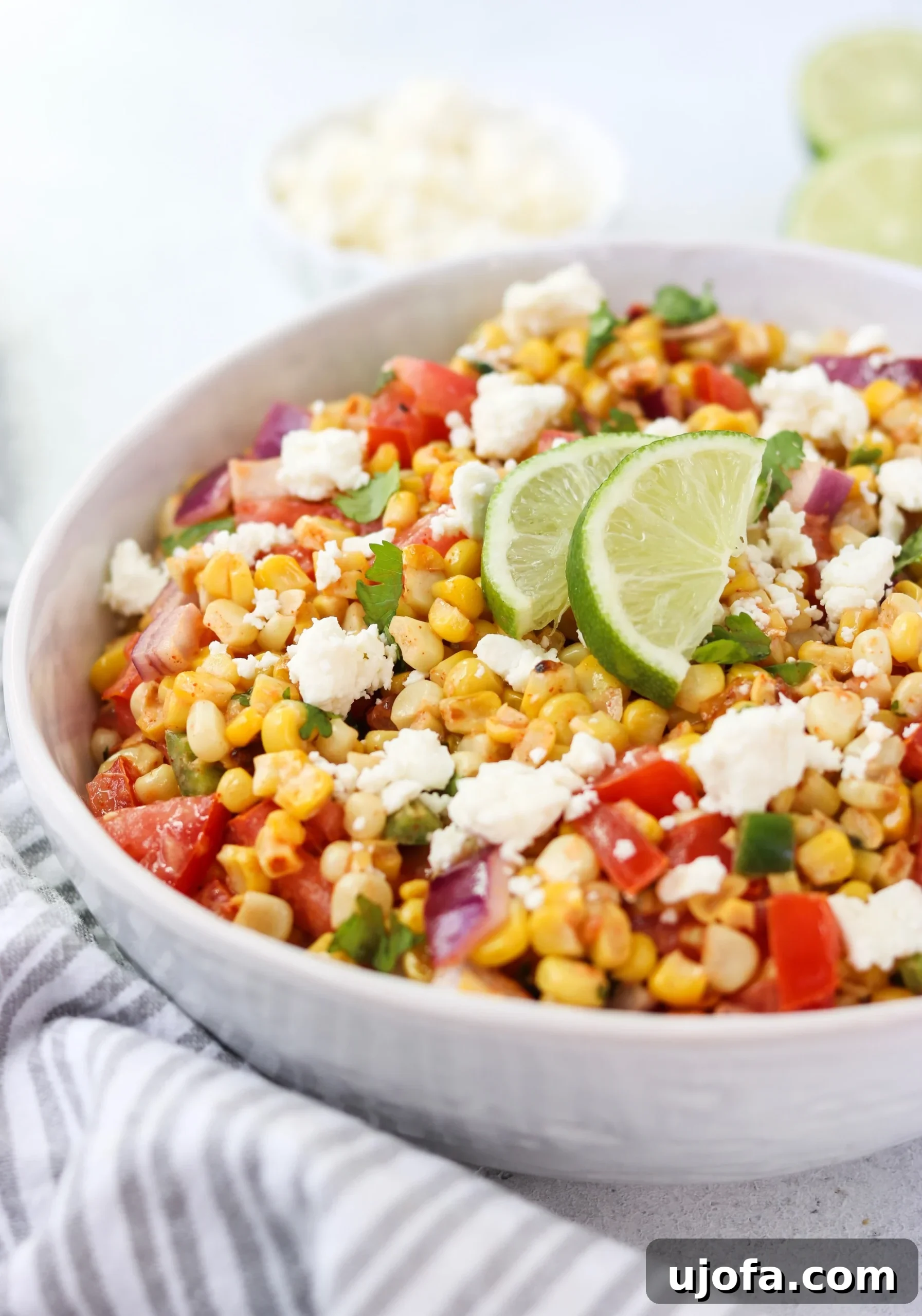 Vibrant Mexican Street Corn and Tomato Salad in a serving bowl, garnished with cilantro.