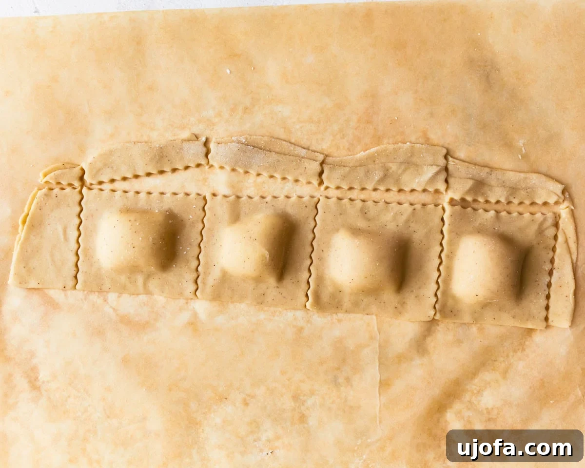 Gluten-free ravioli dough stuffed with filling and cut to shape.