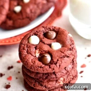 A stack of vibrant gluten-free red velvet chocolate chip cookies, showcasing their rich color and gooey chocolate chips.