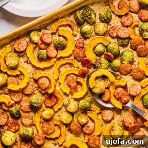 Sheet Pan Roasted Delicata Squash and Chicken Sausage 10 A side view of a delicata squash sheet pan dinner, showcasing the perfectly roasted ingredients.