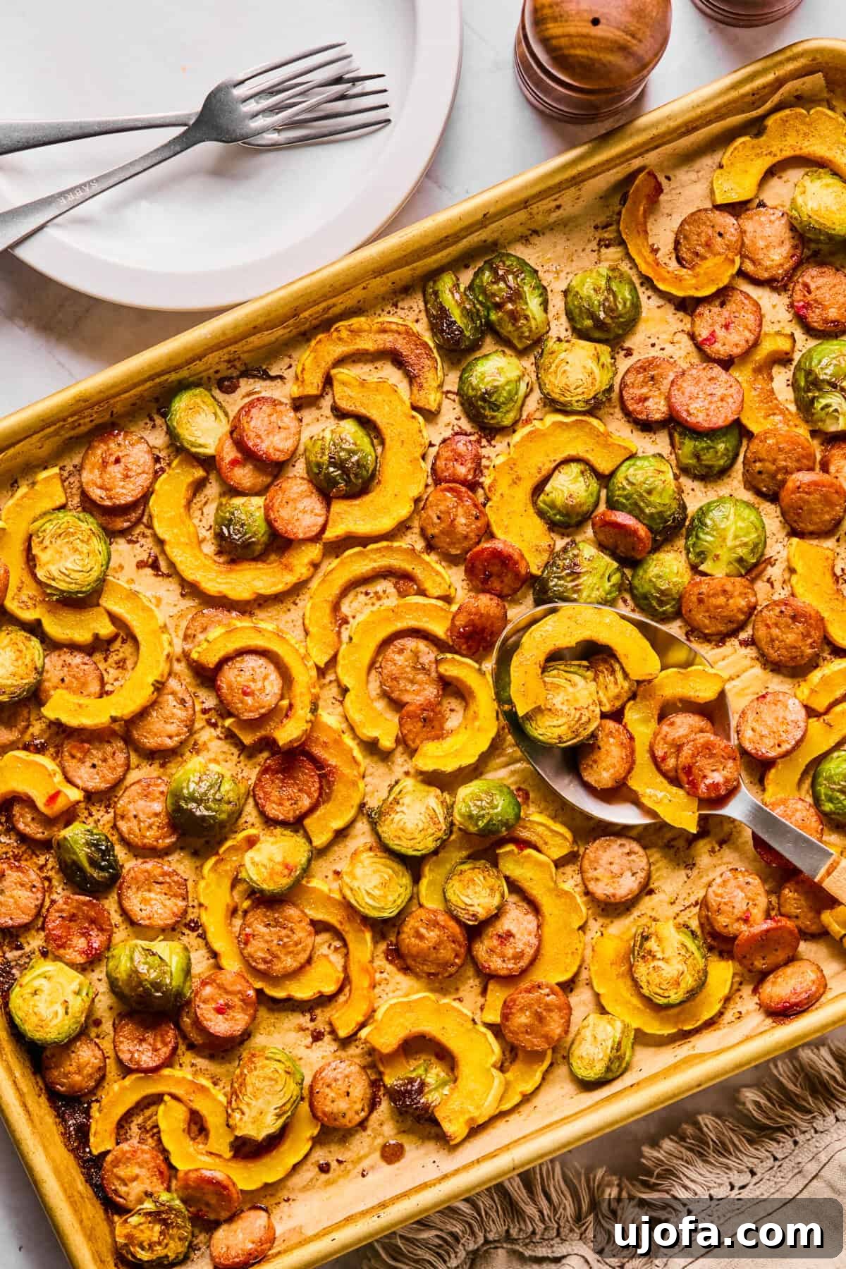 Sheet Pan Roasted Delicata Squash and Chicken Sausage 8 A beautiful side view of the roasted delicata squash, chicken sausage, and Brussels sprouts, showcasing their golden-brown perfection.