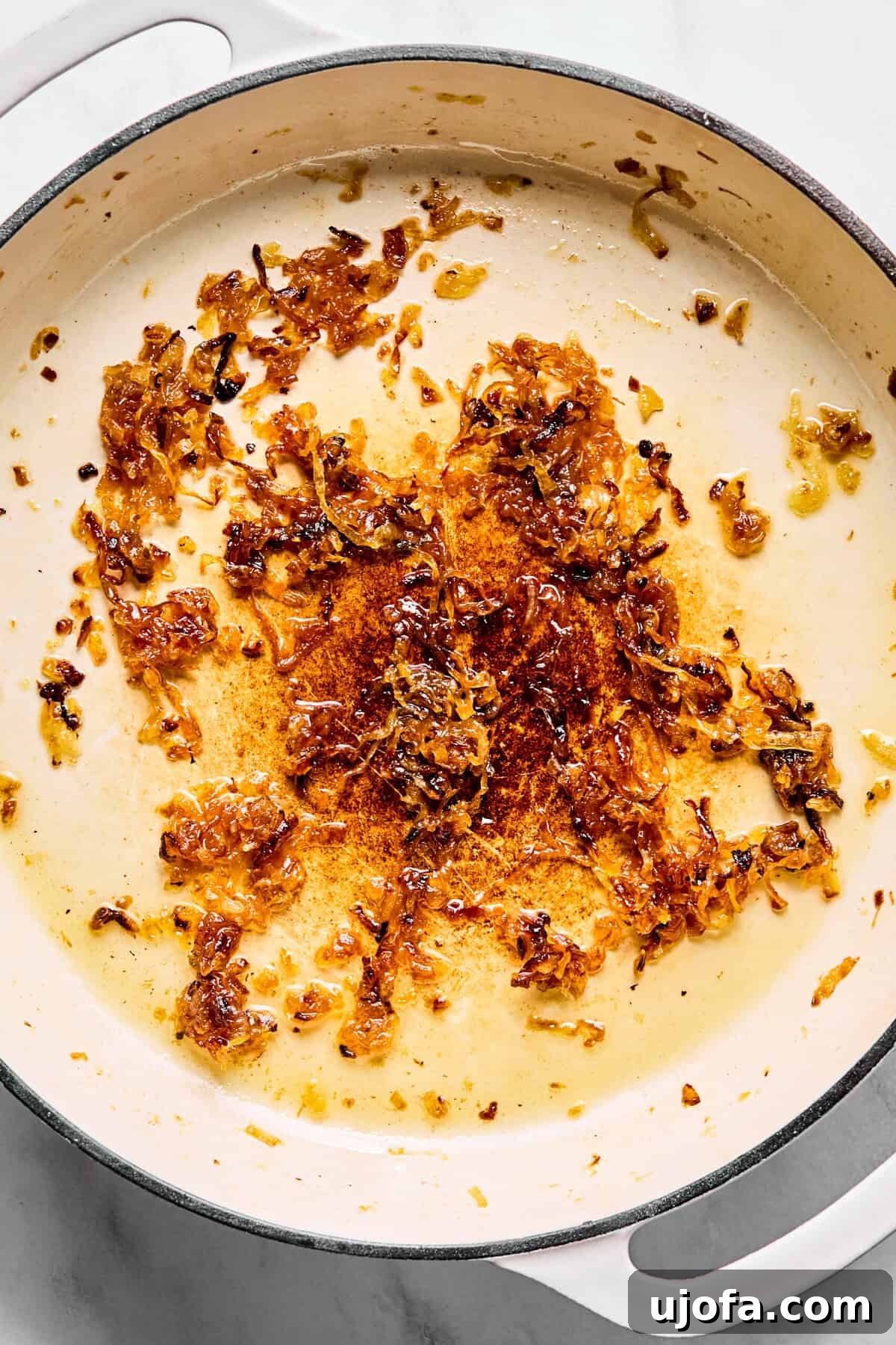 Savory French Onion Meatballs with Rich Gravy 5 Large oven-safe skillet with deeply browned and softened caramelized onions, reduced in volume.
