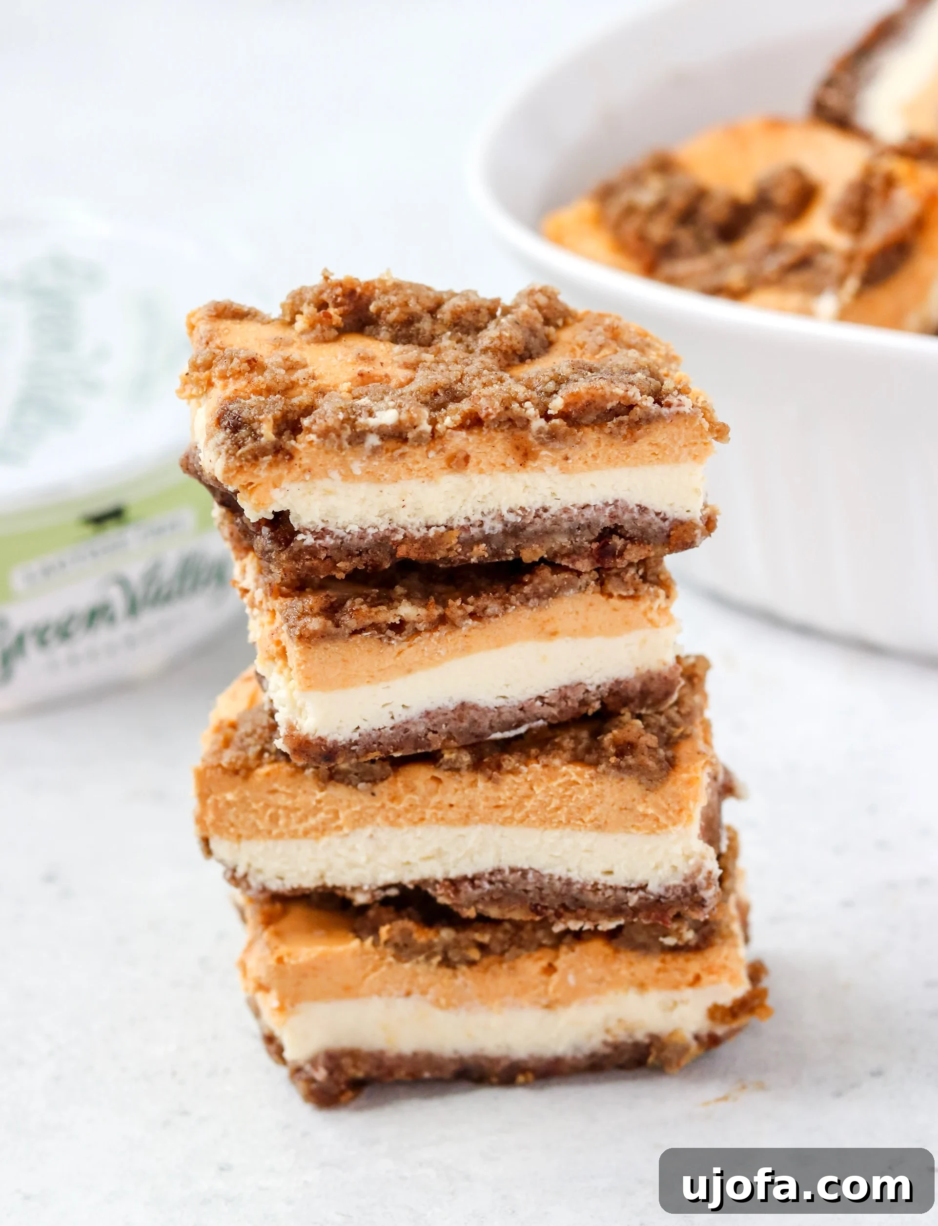 Delightful Dairy-Free Grain-Free Pumpkin Cheesecake Bars 4 Layers of cheesecake bars with streusel topping