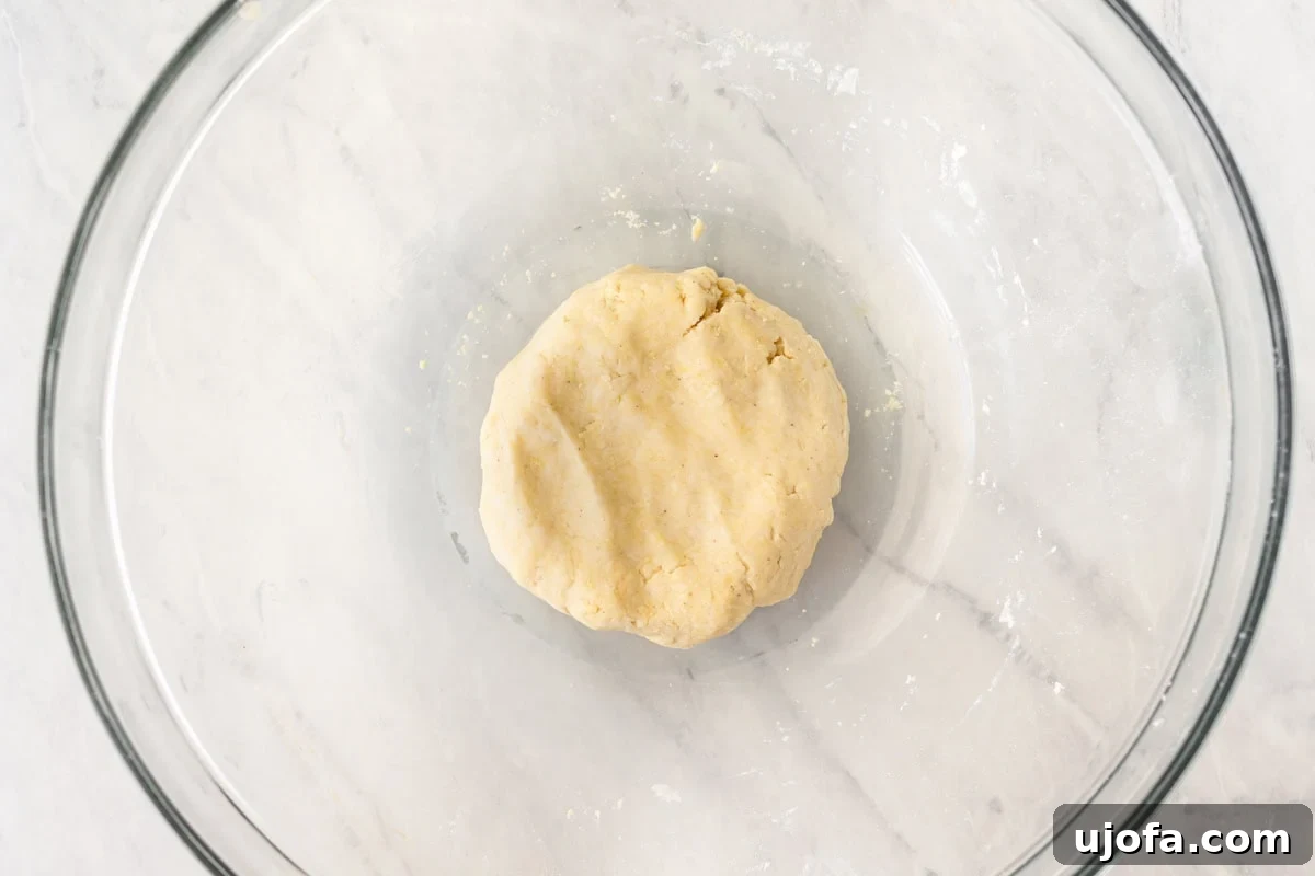 Crafting Gluten-Free Wonton Delights 8 A smooth, cohesive ball of gluten-free wonton wrapper dough resting in a glass mixing bowl after kneading.