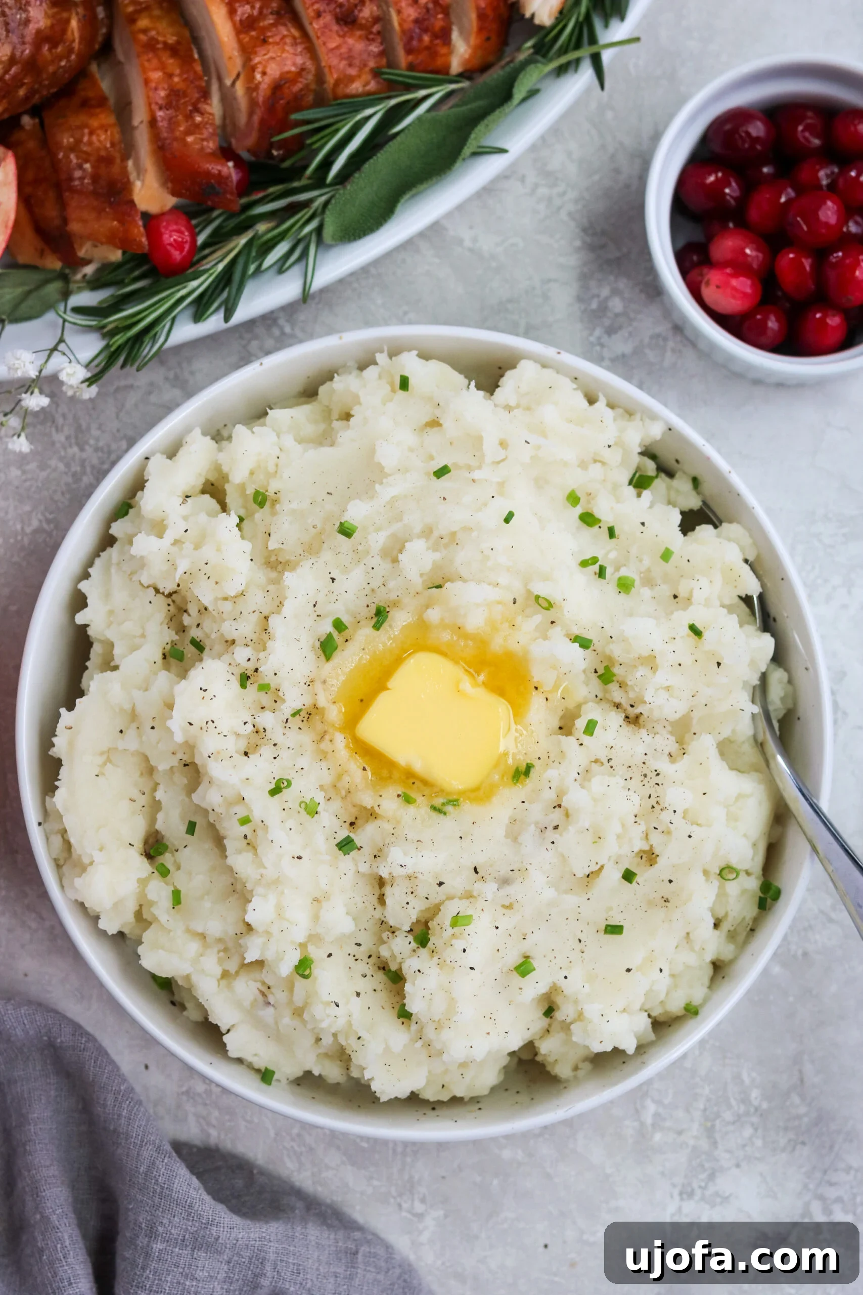 Buttery Smooth Dairy-Free Mash 2 Whole30 mashed potatoes with vegan butter and chives in a white bowl