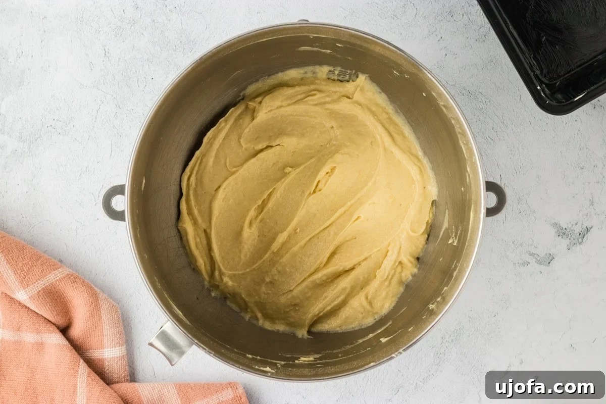 Gluten-free brioche batter after being mixed on medium speed until smooth and resembling cake batter.