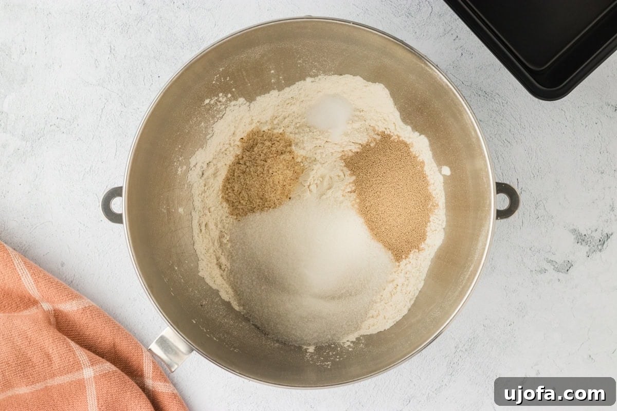 Gluten-free flour, sugar, psyllium husk, and instant yeast in a mixing bowl, ready for combining.
