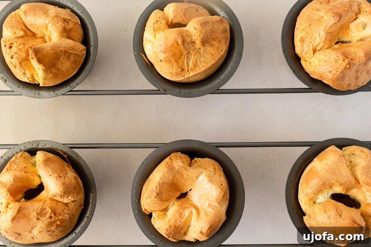 Overhead view of gluten-free popovers baking and rising beautifully in a popover pan.