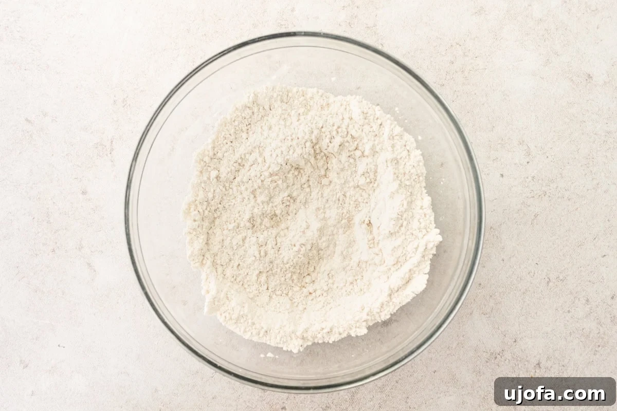 Dry ingredients for gluten-free popovers in a glass mixing bowl, perfectly combined.