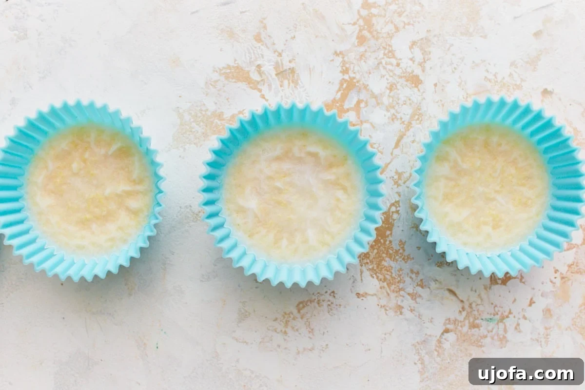 Solidified blocks of homemade vegan butter in silicone molds, indicating that the butter has set firm and is ready to be removed and enjoyed. The texture appears smooth and consistent.