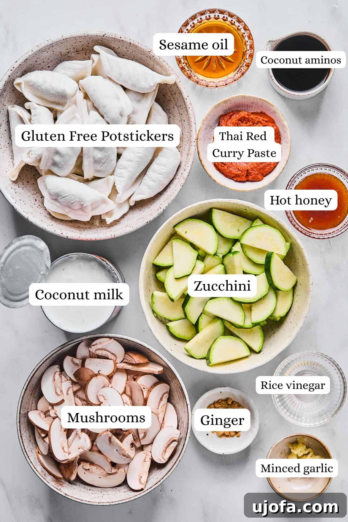 A collection of fresh ingredients for the viral baked dumplings, neatly arranged in nesting bowls on a wooden surface.