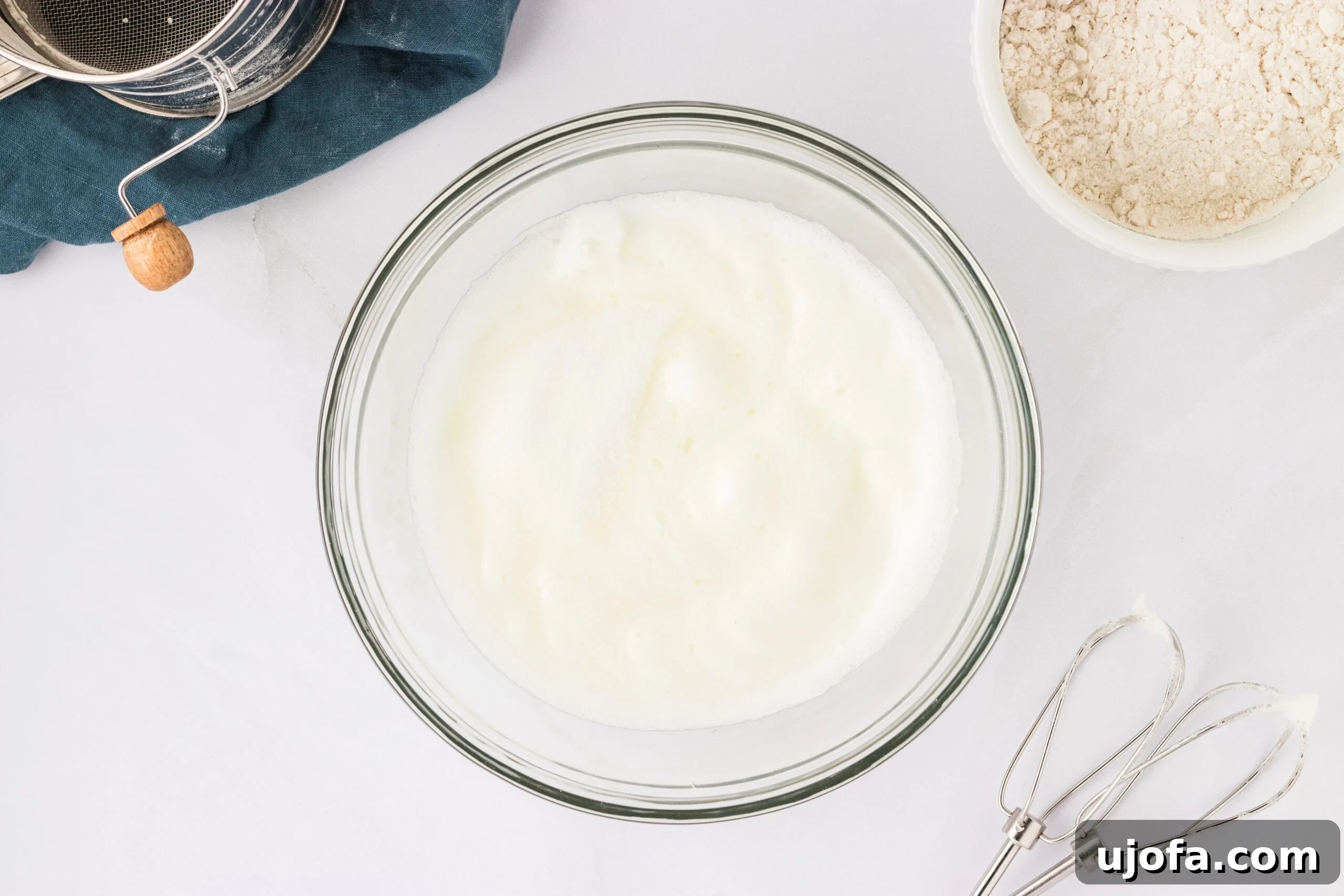 The Ultimate Gluten-Free Ladyfingers 11 whipped egg whites in glass bowl on white counter top