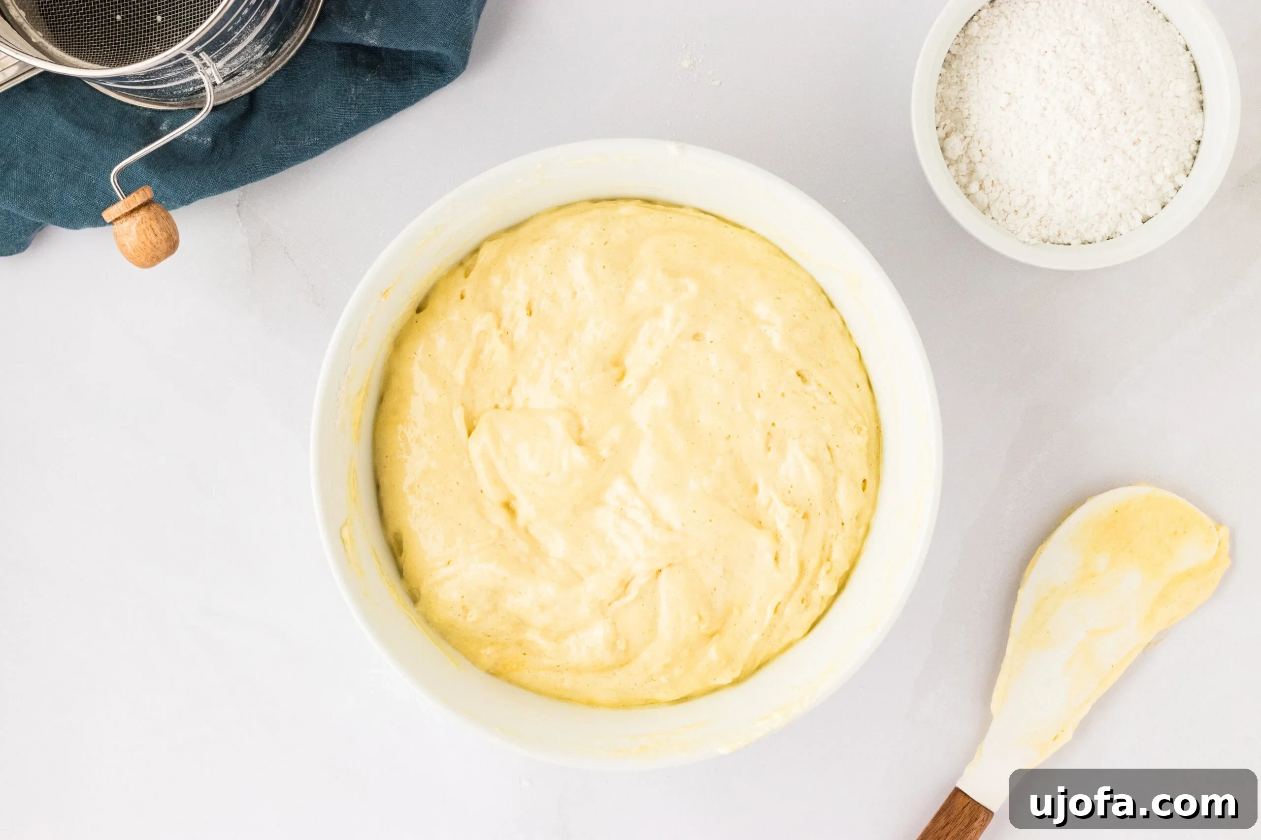 The Ultimate Gluten-Free Ladyfingers 15 ladyfinger dough in white bowl on counter with spatula next to bowl