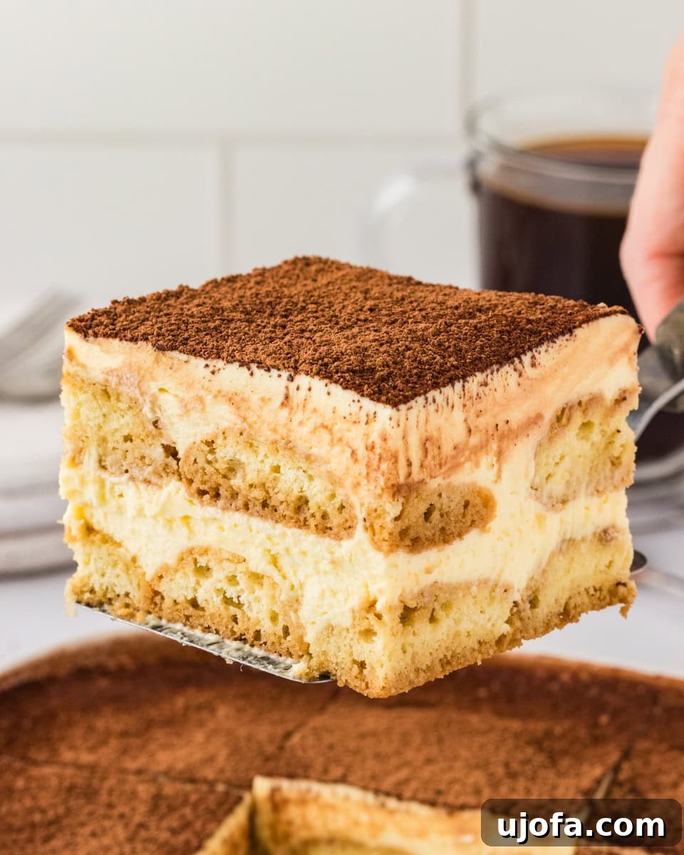 piece of tiramisu being lifted out of pan with spatula