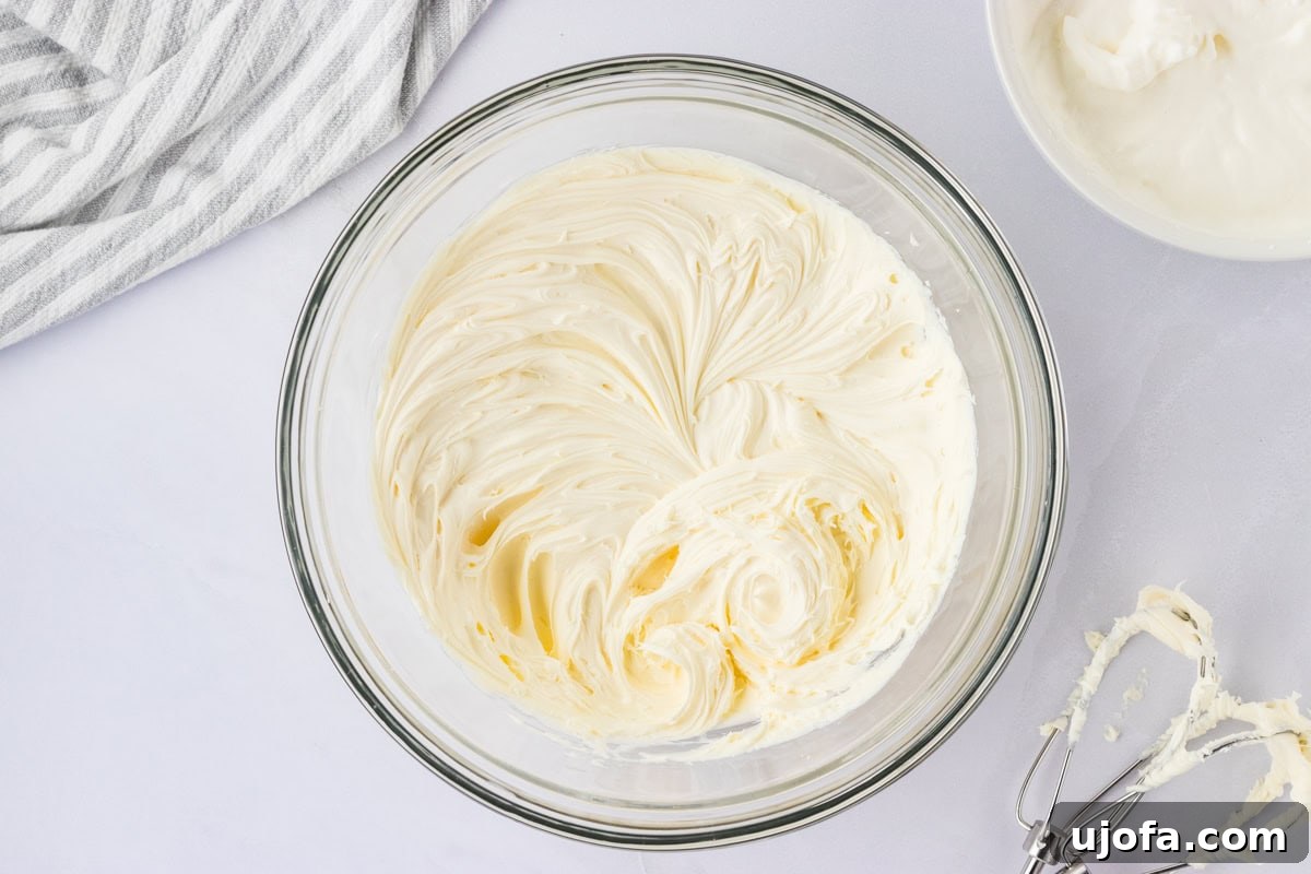 whipped mascarpone and salt in glass mixing bowl