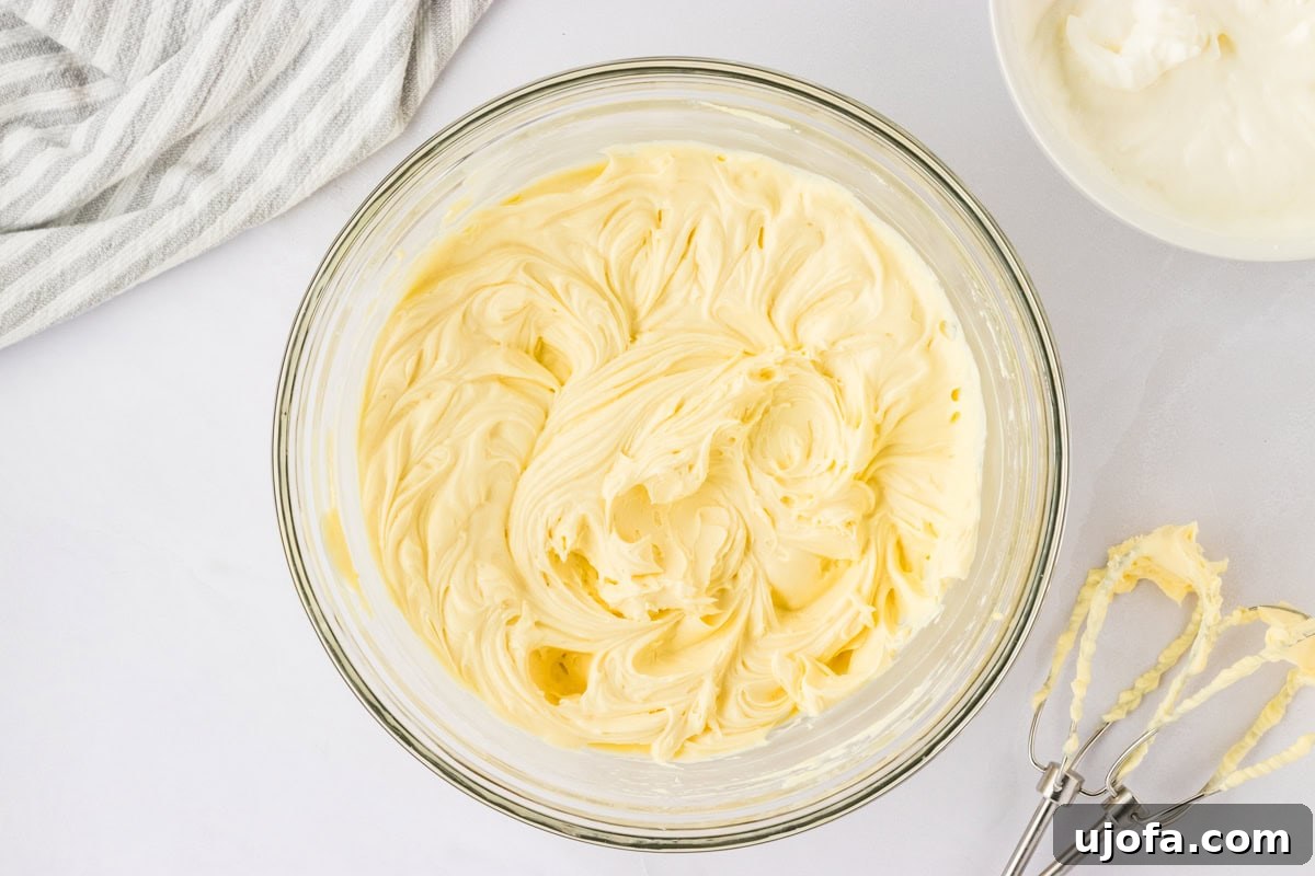 whipped egg yolk mix and whipped cream in glass bowl